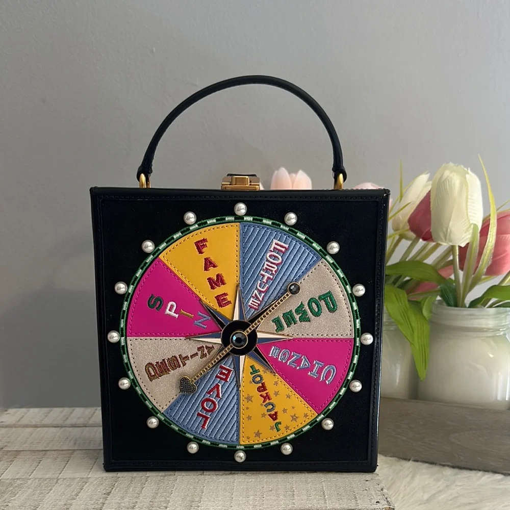 Kate spade fortune favors 3D embellished wheel bag